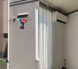 "エアコン設置工事現場の様子：壁穴開けと配管設置作業