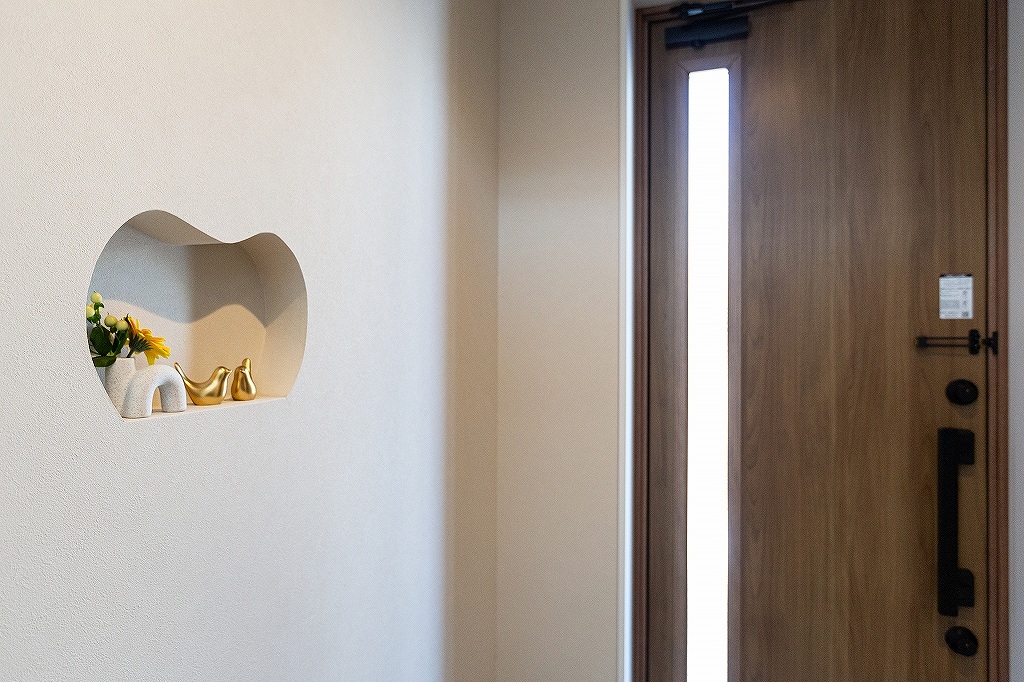 リノベーション後：奥様デザインの曲線ニッチ 小物を飾れる玄関の装飾スペース